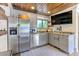 Modern outdoor kitchen featuring stainless steel appliances, gray cabinetry, ample counter space, and a tv at 125 Foxridge Rd, Atlanta, GA 30327
