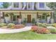 Inviting porch with cozy seating, flowerbeds and well-kept plants create a welcoming entrance at 125 Foxridge Rd, Atlanta, GA 30327