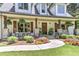 Charming front porch with stone columns, hanging plants, and rocking chairs at 125 Foxridge Rd, Atlanta, GA 30327