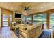 Beautiful sun room with wood ceiling, stone fireplace, and outdoor views at 125 Foxridge Rd, Atlanta, GA 30327