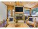 Relaxing sun room with stone fireplace and wooded views at 125 Foxridge Rd, Atlanta, GA 30327