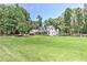 Sprawling lawn surrounds this beautiful home with mature trees and thoughtful landscaping at 125 Foxridge Rd, Atlanta, GA 30327