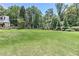 Expansive green lawn with mature trees creates a private and serene outdoor space at 125 Foxridge Rd, Atlanta, GA 30327