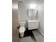 A bathroom featuring a toilet, floating vanity, and a mirror at 172 Haynes Sw St # 107, Atlanta, GA 30313