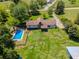 Aerial view featuring a house with a pool, garden, and a fire pit area at 3769 Bay Creek Church Rd, Loganville, GA 30052