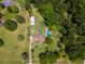 Aerial view of the property featuring the home, pool, and surrounding trees at 3769 Bay Creek Church Rd, Loganville, GA 30052