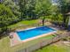 Aerial view of a fenced-in backyard with an inground pool and lush greenery at 3769 Bay Creek Church Rd, Loganville, GA 30052