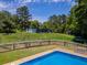 Large fenced in backyard with a swimming pool, storage shed, and trampoline at 3769 Bay Creek Church Rd, Loganville, GA 30052
