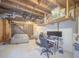 Unfinished basement with exposed ceiling, stairs, computer setup and potential for customization at 3769 Bay Creek Church Rd, Loganville, GA 30052