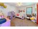 Cozy bedroom with a dollhouse and natural light, perfect for creative play and relaxation at 3769 Bay Creek Church Rd, Loganville, GA 30052