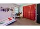 Cheerful bedroom featuring red closet doors and a cozy bed, creating a warm and inviting space at 3769 Bay Creek Church Rd, Loganville, GA 30052