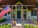 Inviting front porch with iron railings and a prominent American flag at 3769 Bay Creek Church Rd, Loganville, GA 30052