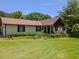 Ranch-style home with a manicured lawn, garden, and a charming front porch at 3769 Bay Creek Church Rd, Loganville, GA 30052