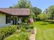 Landscaped front yard featuring a stone walkway, green grass, and an American flag at 3769 Bay Creek Church Rd, Loganville, GA 30052