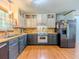 Traditional kitchen featuring two-tone cabinetry, stainless steel appliances and natural wood countertops at 3769 Bay Creek Church Rd, Loganville, GA 30052