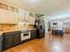 Open concept kitchen featuring dining area, stainless steel appliances and two-tone cabinetry at 3769 Bay Creek Church Rd, Loganville, GA 30052