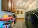 Functional laundry room with plentiful storage and laundry machines at 3769 Bay Creek Church Rd, Loganville, GA 30052