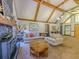Open-concept living room with vaulted ceilings, exposed beams, fireplace and a large sectional sofa at 3769 Bay Creek Church Rd, Loganville, GA 30052