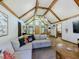 Cozy living room featuring vaulted ceilings with wood beams and comfortable seating at 3769 Bay Creek Church Rd, Loganville, GA 30052