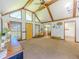 Bright living room with vaulted ceilings, wood beams, multiple windows and yellow door at 3769 Bay Creek Church Rd, Loganville, GA 30052