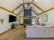 Spacious living room featuring vaulted ceilings, wood beams, and a stone fireplace at 3769 Bay Creek Church Rd, Loganville, GA 30052