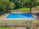 Beautiful in-ground pool is fenced in with lounge chairs on the side at 3769 Bay Creek Church Rd, Loganville, GA 30052