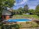 Fenced in pool with chairs overlooking a large yard with a shed in the background at 3769 Bay Creek Church Rd, Loganville, GA 30052