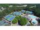 Aerial view of community amenities, tennis courts, swimming pool with slide, clubhouse and manicured green space at 8970 Moor Park Run, Duluth, GA 30097