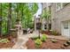 Beautiful backyard with a stone fireplace, patio, manicured landscaping, and access to the main house at 8970 Moor Park Run, Duluth, GA 30097