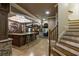 Expansive basement boasting a wet bar, elegant bar stools, and luxury finishes at 8970 Moor Park Run, Duluth, GA 30097
