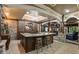 Finished basement featuring a granite-topped bar, stone accents, a ceiling fan and stylish decor at 8970 Moor Park Run, Duluth, GA 30097
