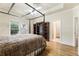 Bedroom with a four-poster bed, ceiling fan, and two doors, offering comfort and convenience at 8970 Moor Park Run, Duluth, GA 30097