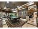 Billiard room boasts rich wood accents, coffered ceilings, and large windows at 8970 Moor Park Run, Duluth, GA 30097