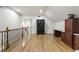 Spacious bonus room with hardwood floors, desk, and black storage cabinet offers versatile living space at 8970 Moor Park Run, Duluth, GA 30097