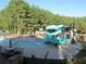 Community pool area with slide, water feature and relaxing seating areas, perfect for outdoor enjoyment at 8970 Moor Park Run, Duluth, GA 30097