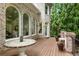 Large wooden deck featuring stone top dining table with private backyard view at 8970 Moor Park Run, Duluth, GA 30097