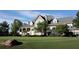 Clubhouse exterior view with golf course in foreground and covered porch featuring beautiful architecture at 8970 Moor Park Run, Duluth, GA 30097