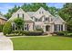 Charming two-story brick home with lush landscaping and a well-manicured lawn at 8970 Moor Park Run, Duluth, GA 30097