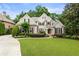 Inviting two-story brick home with mature trees, green lawn and manicured shrubbery at 8970 Moor Park Run, Duluth, GA 30097
