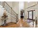 Elegant foyer with hardwood floors, staircase and stained glass front door at 8970 Moor Park Run, Duluth, GA 30097