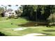Scenic view of golf course with sand trap, pond, and luxury homes in a lush landscape at 8970 Moor Park Run, Duluth, GA 30097