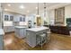 Open kitchen with marble countertops, stainless steel appliances and seamless view into the living room at 8970 Moor Park Run, Duluth, GA 30097