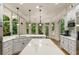 Bright kitchen with white cabinets, marble counters, pendant lighting and breakfast nook with backyard views at 8970 Moor Park Run, Duluth, GA 30097