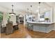 Open-concept kitchen with a large island, marble countertops, and a breakfast area at 8970 Moor Park Run, Duluth, GA 30097
