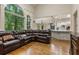 Open concept living room view towards kitchen, hardwood floors and backyard views at 8970 Moor Park Run, Duluth, GA 30097
