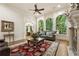 Bright and airy living room featuring a view of the wooded landscape and traditional decor at 8970 Moor Park Run, Duluth, GA 30097