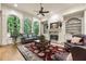 Cozy living room with large windows, fireplace and custom built-ins at 8970 Moor Park Run, Duluth, GA 30097
