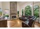 Spacious living room with stone fireplace and hardwood floors at 8970 Moor Park Run, Duluth, GA 30097