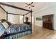 Main bedroom with hardwood floors, tray ceiling, and ensuite access at 8970 Moor Park Run, Duluth, GA 30097