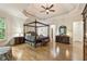 View of a spacious main bedroom with hardwood floors and tray ceiling at 8970 Moor Park Run, Duluth, GA 30097